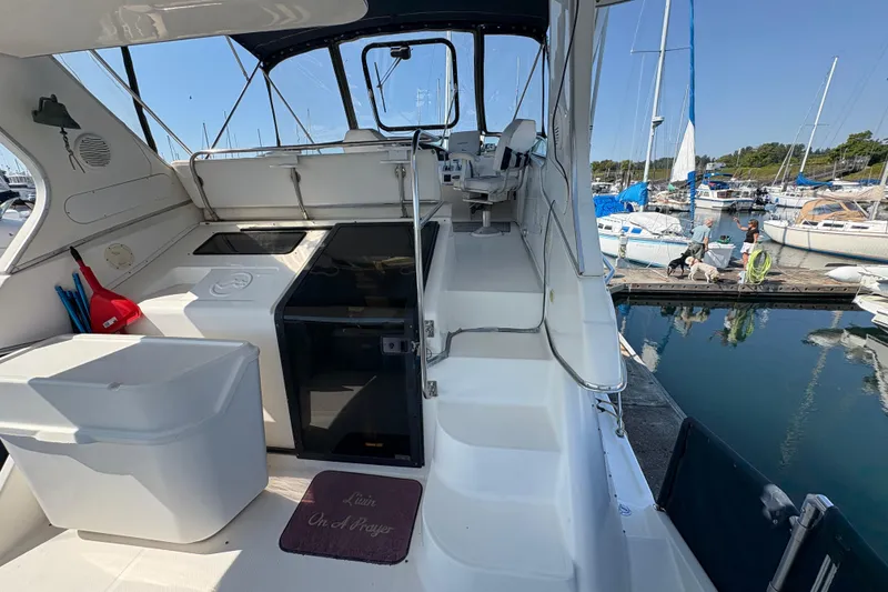Slide: The Image of 1988 Bayliner 3587 Motoryacht interior with marina view, featuring helm and seating area. - 25
