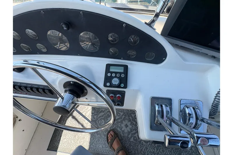 Slide: The Image of 1988 Bayliner 3587 Motoryacht helm with steering wheel, gauges, and controls. - 34