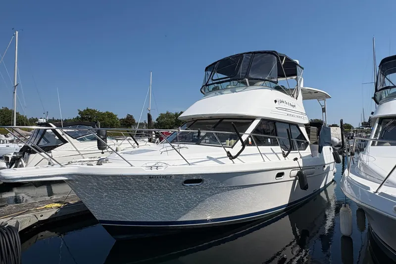Slide: The Image of 1988 Bayliner 3587 Motoryacht docked at marina under clear blue sky. - 4