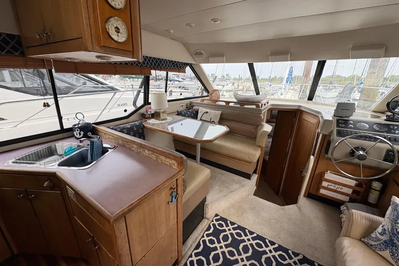 Slide: The Image of Interior of 1988 Bayliner 3587 Motoryacht with helm, seating, and kitchenette. - 44