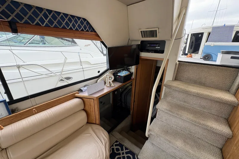 Slide: The Image of Interior of 1988 Bayliner 3587 Motoryacht with stairs, seating, and window view. - 52