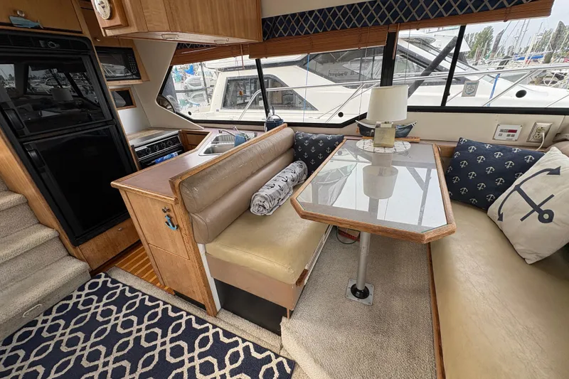 Slide: The Image of Interior of 1988 Bayliner 3587 Motoryacht with dining area and nautical decor. - 56