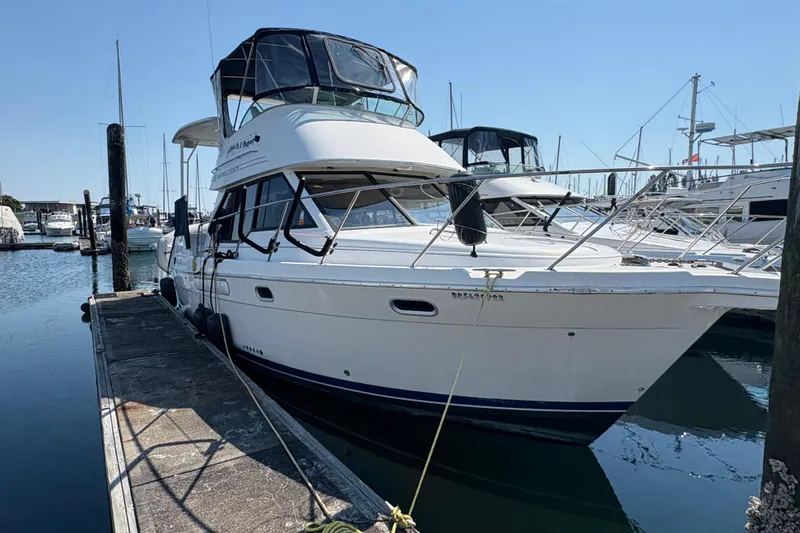 Slide: The Image of 1988 Bayliner 3587 Motoryacht docked at marina under clear blue sky. - 7