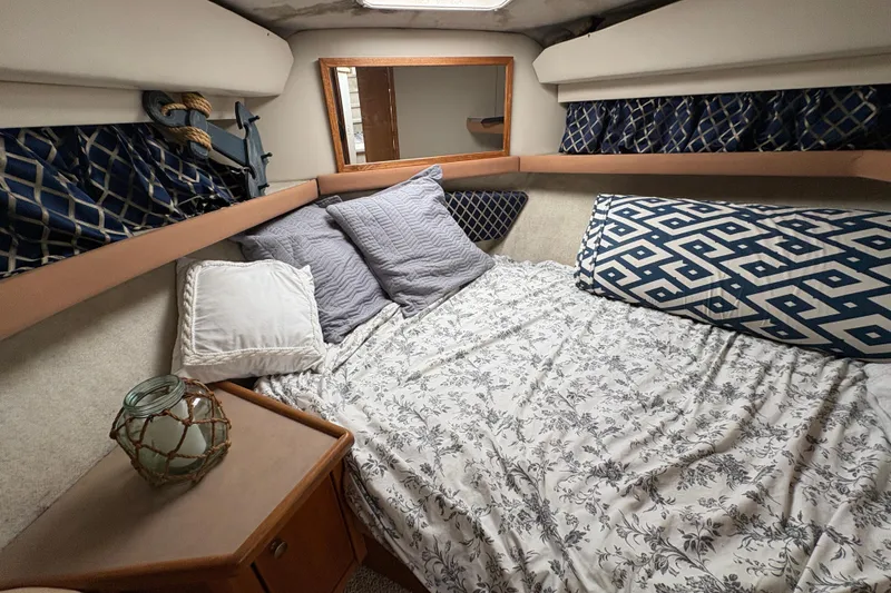 Slide: The Image of Cozy cabin interior of 1988 Bayliner 3587 Motoryacht with patterned bedding and pillows. - 70