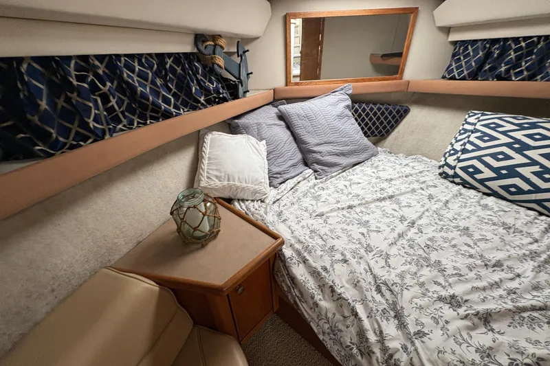 Slide: The Image of Cozy bedroom interior of 1988 Bayliner 3587 Motoryacht with patterned bedding and decorative pillows. - 72