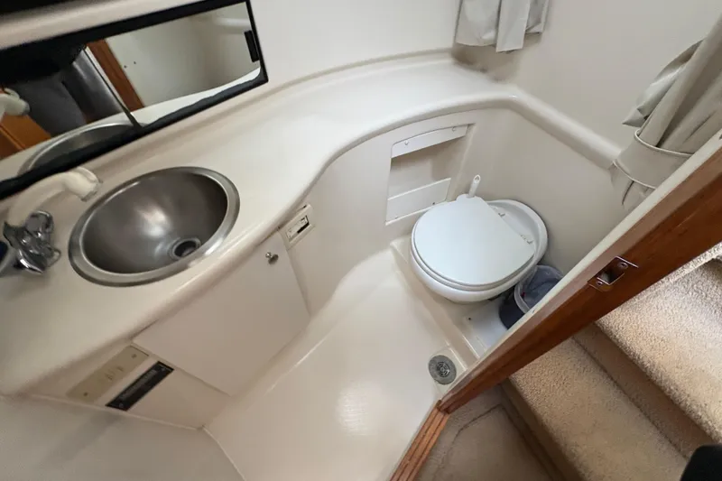 Slide: The Image of 1988 Bayliner 3587 Motoryacht bathroom with sink, toilet, and mirror. - 75