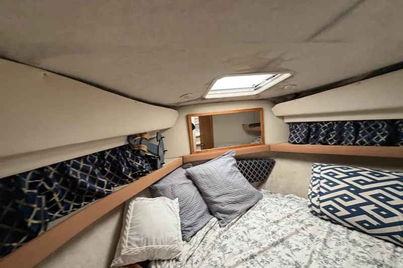 Slide: The Image of Cozy cabin interior of 1988 Bayliner 3587 Motoryacht with patterned pillows and curtains. - 79