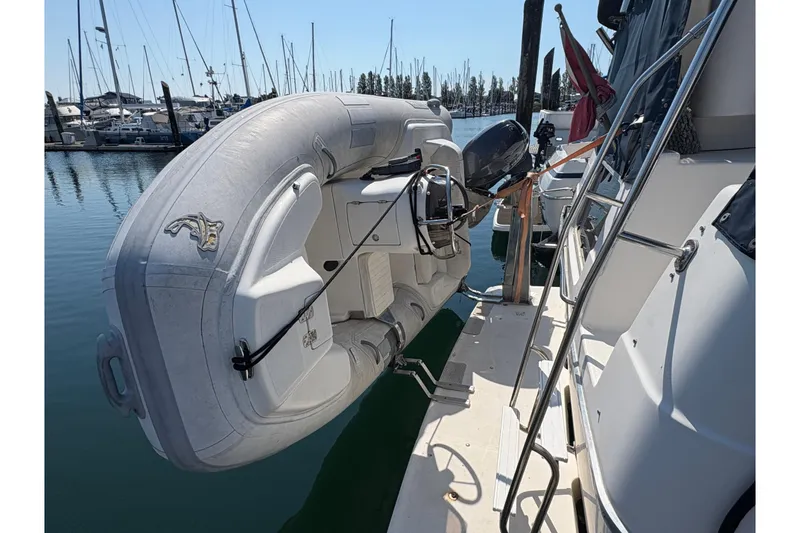 Slide: The Image of 1988 Bayliner 3587 Motoryacht with inflatable dinghy docked at marina. - 8