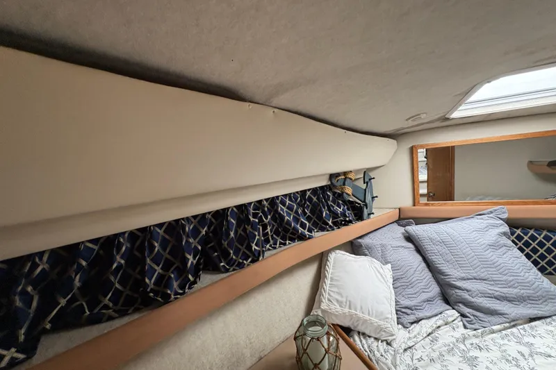 Slide: The Image of Cozy cabin interior of 1988 Bayliner 3587 Motoryacht with pillows and decorative curtains. - 80