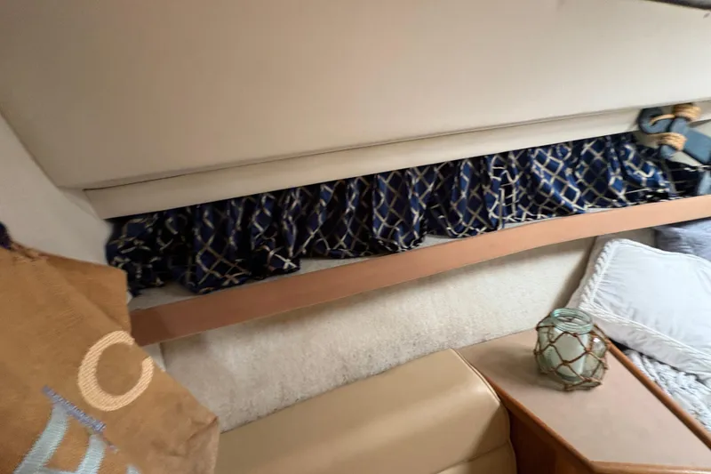 Slide: The Image of Interior of 1988 Bayliner 3587 Motoryacht with blue curtains and cozy seating area. - 81