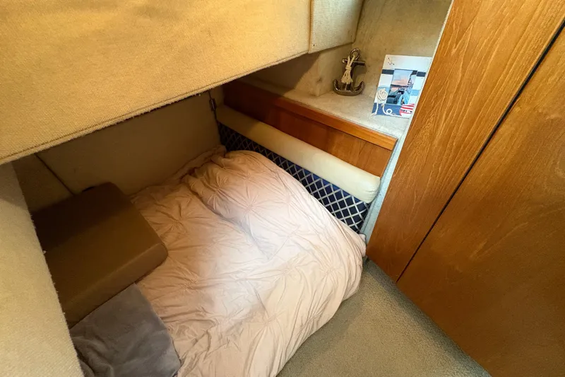Slide: The Image of Cozy cabin interior of 1988 Bayliner 3587 Motoryacht with bed and wooden accents. - 82