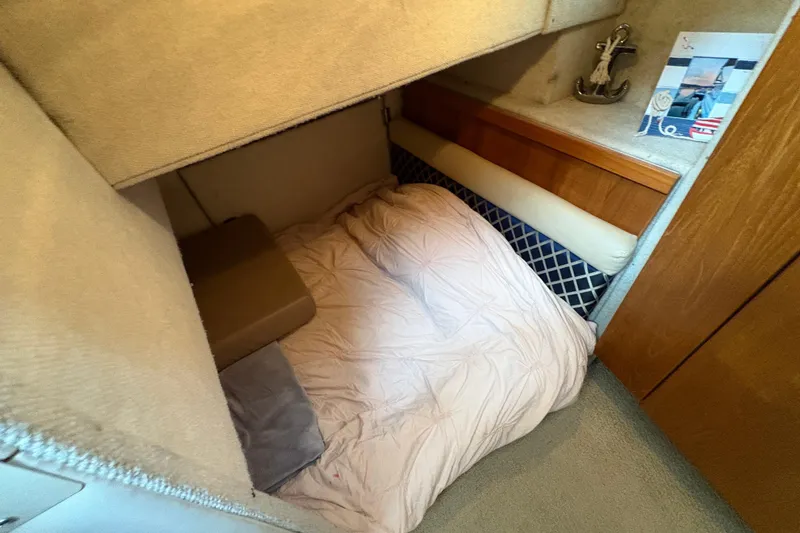 Slide: The Image of Cozy cabin interior of 1988 Bayliner 3587 Motoryacht with bedding and nautical decor. - 83