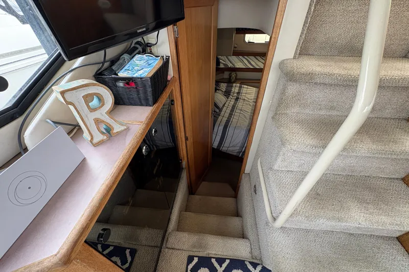 Slide: The Image of Interior of 1988 Bayliner 3587 Motoryacht with stairs, decor, and cozy cabin view. - 86