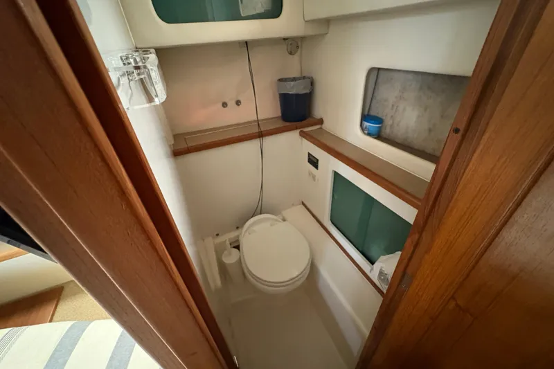 Slide: The Image of 1988 Bayliner 3587 Motoryacht bathroom with compact design and wooden accents. - 91