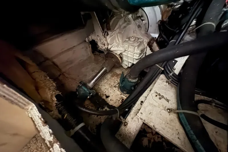 Slide: The Image of Engine compartment of a 1988 Bayliner 3587 Motoryacht, showing mechanical components and hoses. - 98