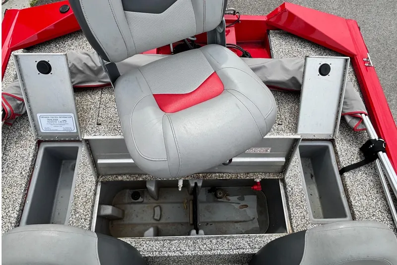 Slide: The Image of 2015 Tracker Pro Team 175 TXW boat interior with gray and red seating. - 10