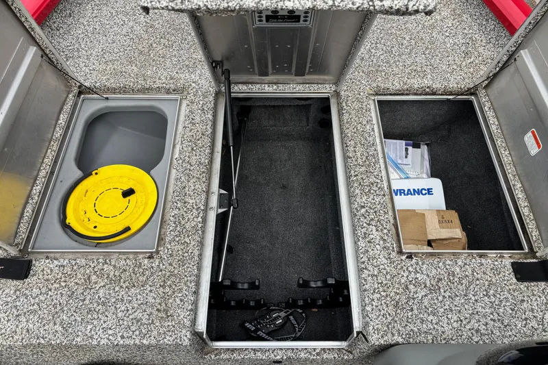 Slide: The Image of 2015 Tracker Pro Team 175 TXW boat storage compartments with yellow lid and equipment. - 5
