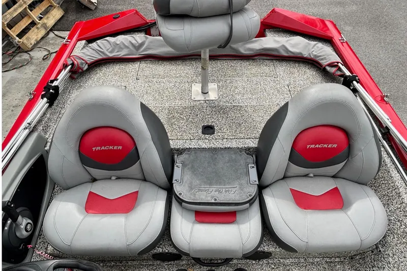 Slide: The Image of 2015 Tracker Pro Team 175 TXW boat interior with red and gray seating. - 8