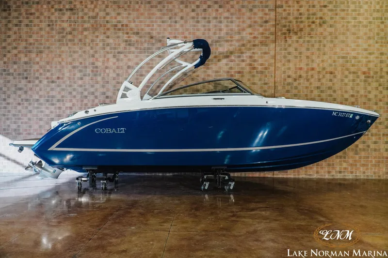 The Image of 2021 Cobalt R5 boat in blue, displayed indoors at Lake Norman Marina. - 1