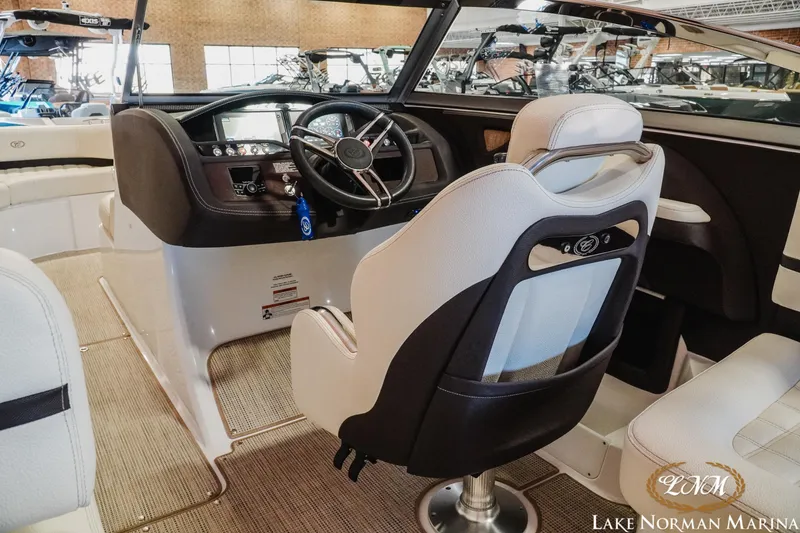 Slide: The Image of Interior of a 2021 Cobalt R5 boat at Lake Norman Marina, featuring a sleek helm. - 11