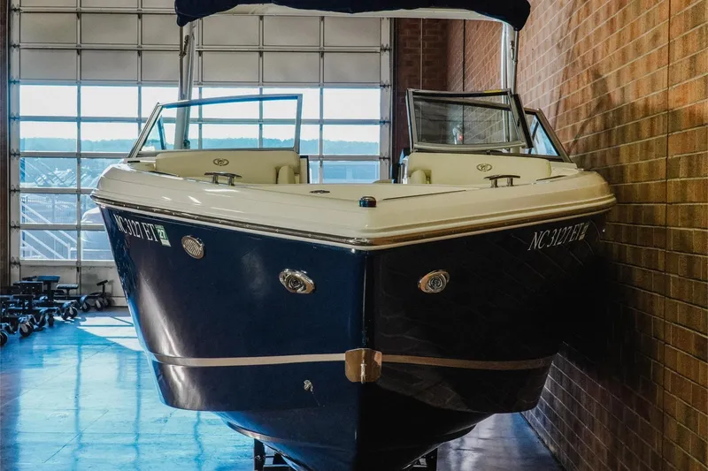 Slide: The Image of 2021 Cobalt R5 boat in indoor storage, showcasing sleek design and modern features. - 4