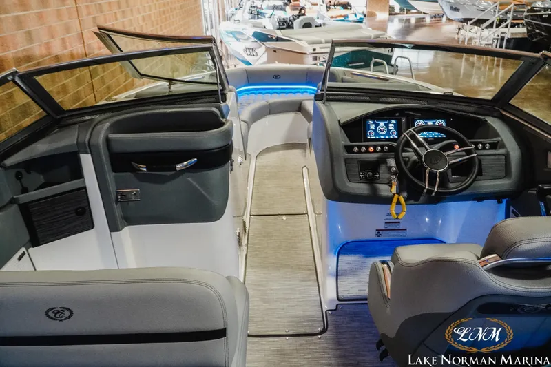 Slide: The Image of Interior view of a 2021 Cobalt R5 boat at Lake Norman Marina, showcasing the helm and seating. - 14