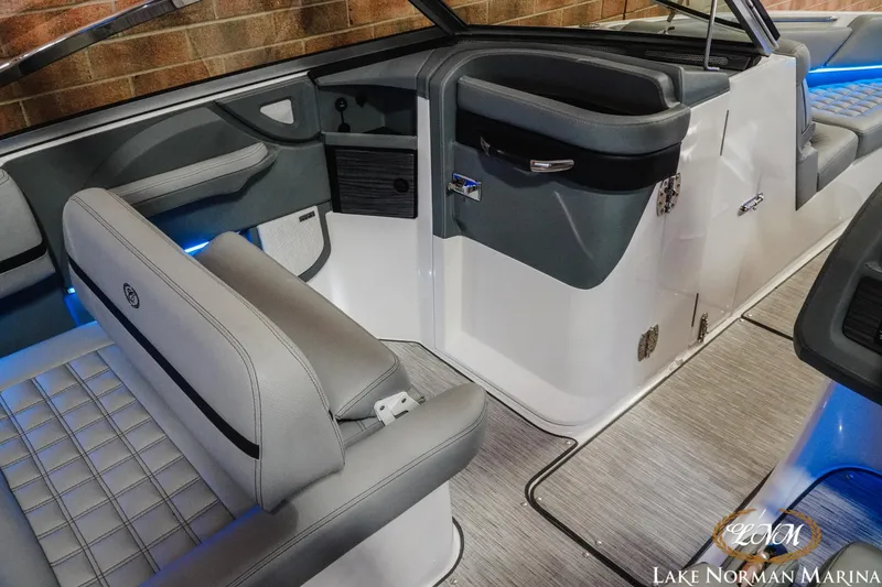 Slide: The Image of Interior of a 2021 Cobalt R5 boat with gray seating and blue accent lighting. - 16