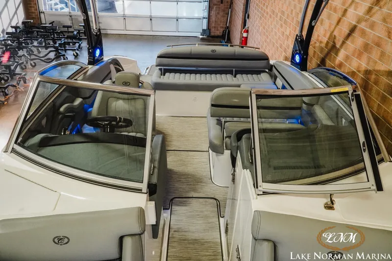 Slide: The Image of 2021 Cobalt R5 boat interior with seating, steering wheel, and windshield at Lake Norman Marina. - 19