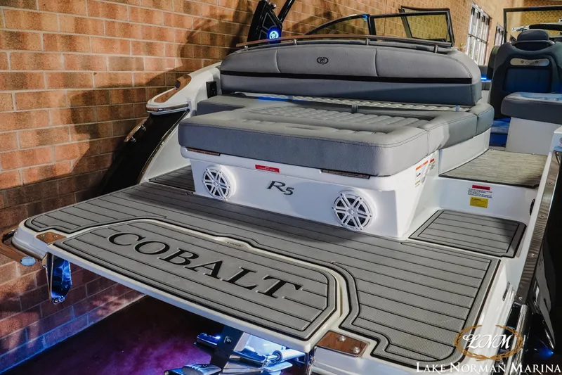 Slide: The Image of 2021 Cobalt R5 boat with gray seating and branded deck at Lake Norman Marina. - 8