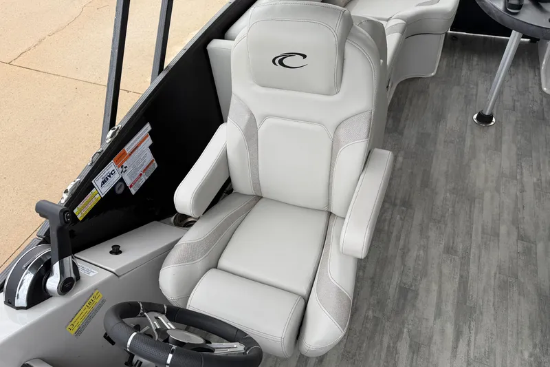 Slide: The Image of Captain's chair in 2023 Crest Caribbean LX 230 boat, featuring sleek design and modern controls. - 12
