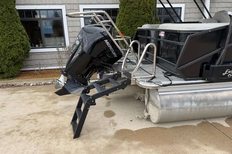 Slide: The Image of 2023 Crest Caribbean LX 230 pontoon boat with Mercury outboard motor and boarding ladder. - 17