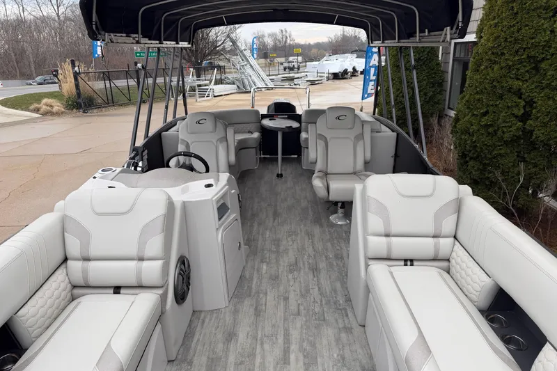 Slide: The Image of 2023 Crest Caribbean LX 230 pontoon boat with spacious seating and modern interior design. - 3