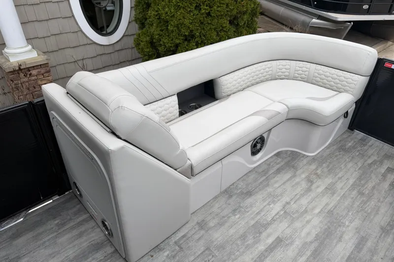 Slide: The Image of Luxurious seating on 2023 Crest Caribbean LX 230 boat, featuring elegant white upholstery. - 6