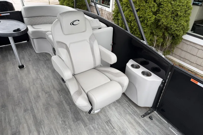 Slide: The Image of Luxurious seating on 2023 Crest Caribbean LX 230 boat with cup holders and table. - 7
