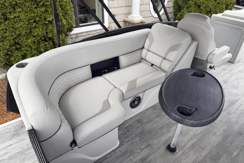 Slide: The Image of 2023 Crest Caribbean LX 230 boat interior with plush seating and round table. - 9