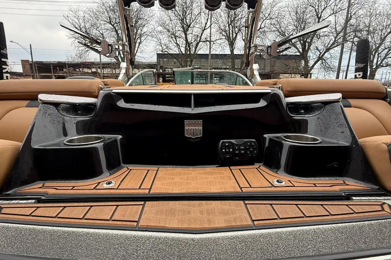 Slide: The Image of 2021 MasterCraft X26 boat interior with cup holders and teak flooring. - 13
