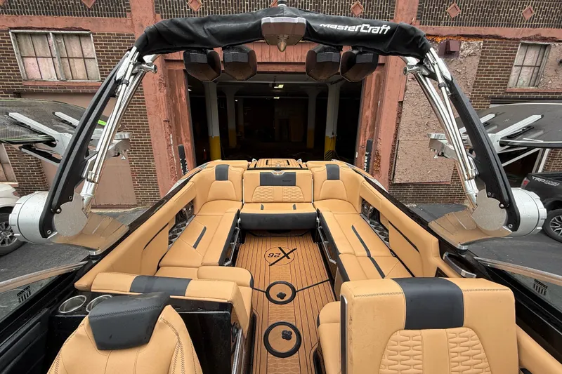 Slide: The Image of 2021 MasterCraft X26 boat interior with tan seating and sleek design. - 15
