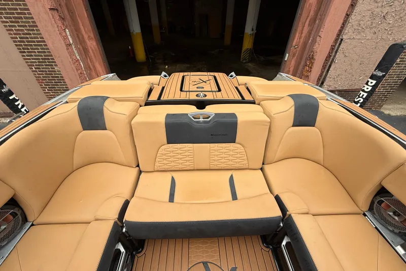Slide: The Image of 2021 MasterCraft X26 boat interior with tan leather seating and stylish design. - 16