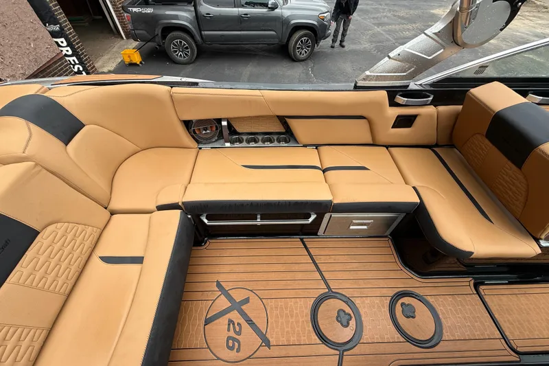 Slide: The Image of Luxurious interior of 2021 MasterCraft X26 boat with tan and black seating. - 18
