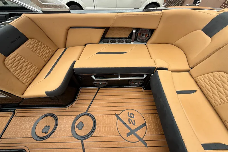Slide: The Image of Luxurious tan seating in 2021 MasterCraft X26 boat interior with stylish design. - 19