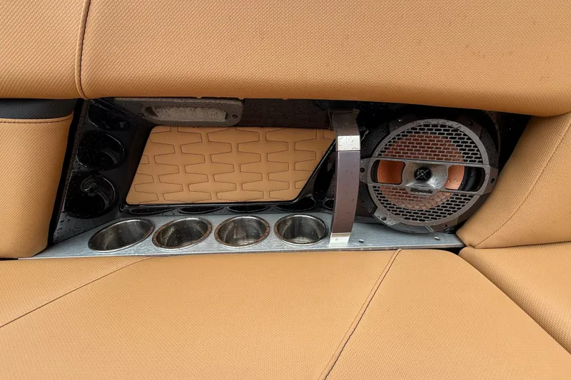 Slide: The Image of 2021 MasterCraft X26 boat interior with cup holders and speaker system. - 21