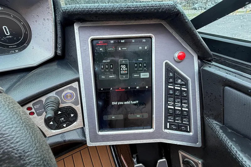 Slide: The Image of 2021 MasterCraft X26 boat dashboard with touchscreen controls and navigation system. - 24