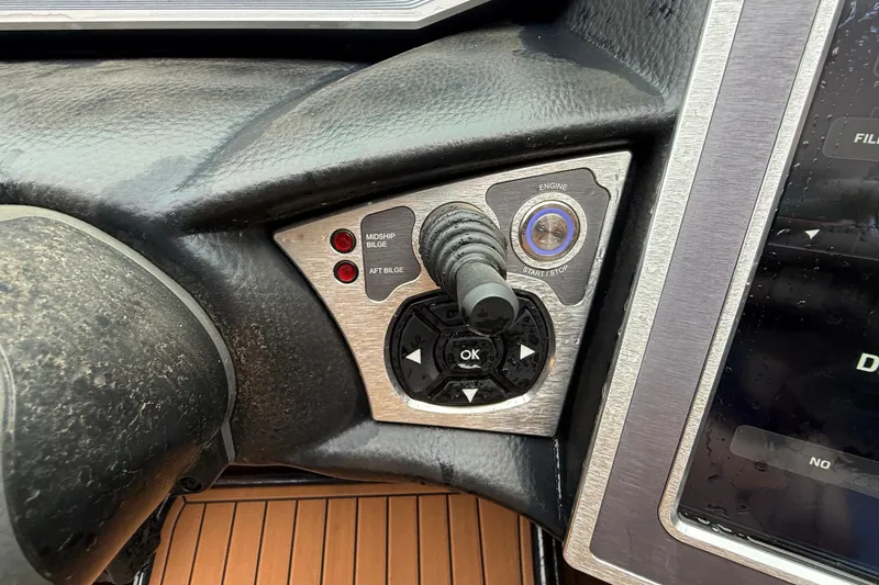 Slide: The Image of 2021 MasterCraft X26 dashboard controls with joystick and start/stop button. - 27