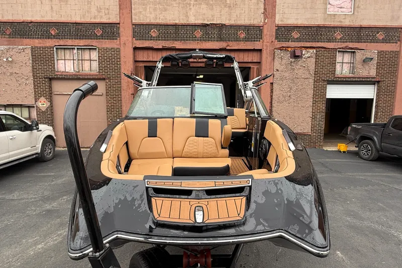 Slide: The Image of 2021 MasterCraft X26 boat with luxurious interior in front of warehouse. - 6