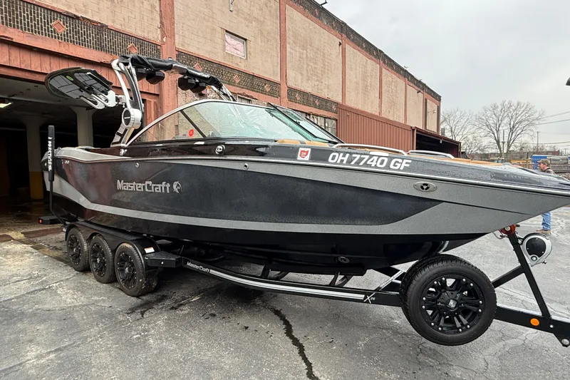 Slide: The Image of 2021 MasterCraft X26 boat on trailer outside industrial building. - 8