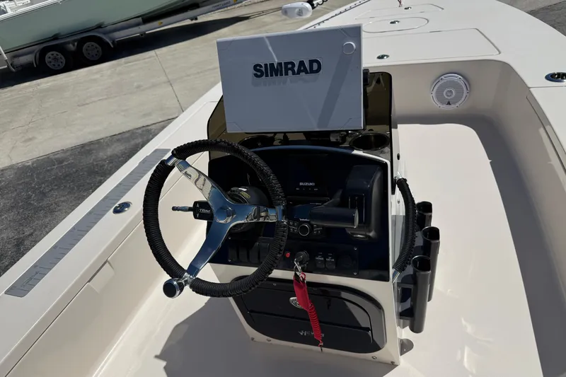 Slide: The Image of 2006 Hewes Redfisher 21 boat console with Simrad navigation system and steering wheel. - 4