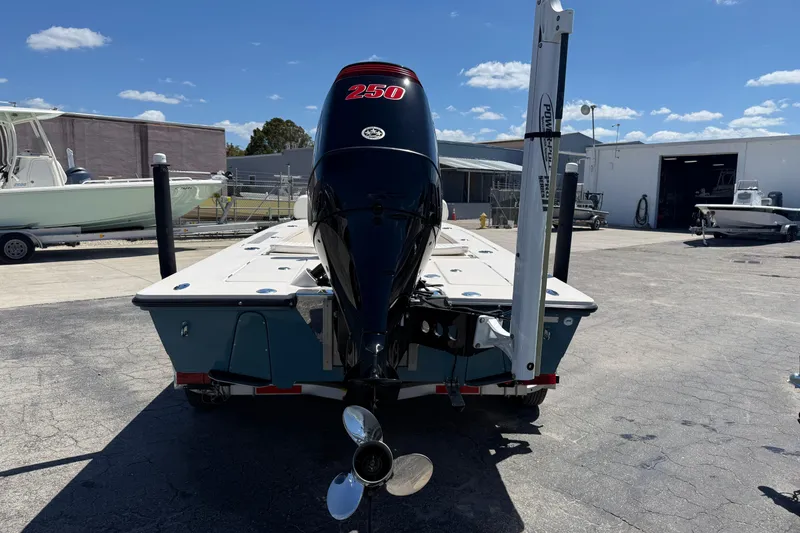 Slide: The Image of 2006 Hewes Redfisher 21 boat with powerful outboard motor in a sunny marina. - 5
