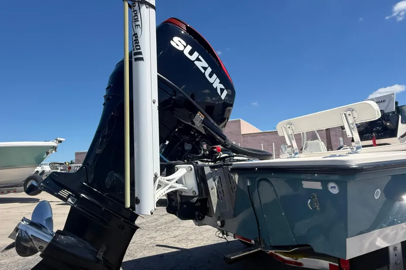 Slide: The Image of 2006 Hewes Redfisher 21 boat with Suzuki outboard motor in a sunny marina. - 6