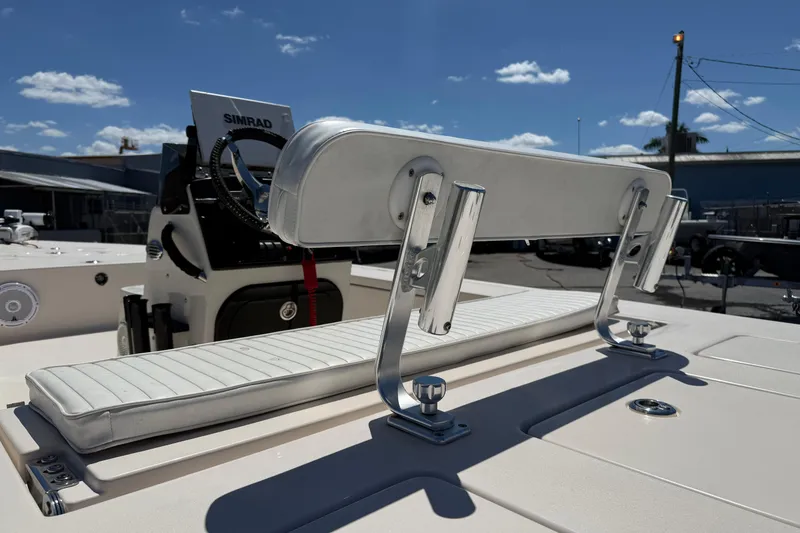 Slide: The Image of 2006 Hewes Redfisher 21 boat with white seating and Simrad electronics under a clear sky. - 8
