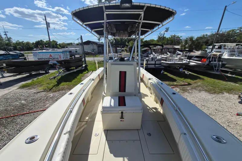 Slide: The Image of 2008 Contender 23 Tournament boat with T-top, parked outdoors under clear blue sky. - 10